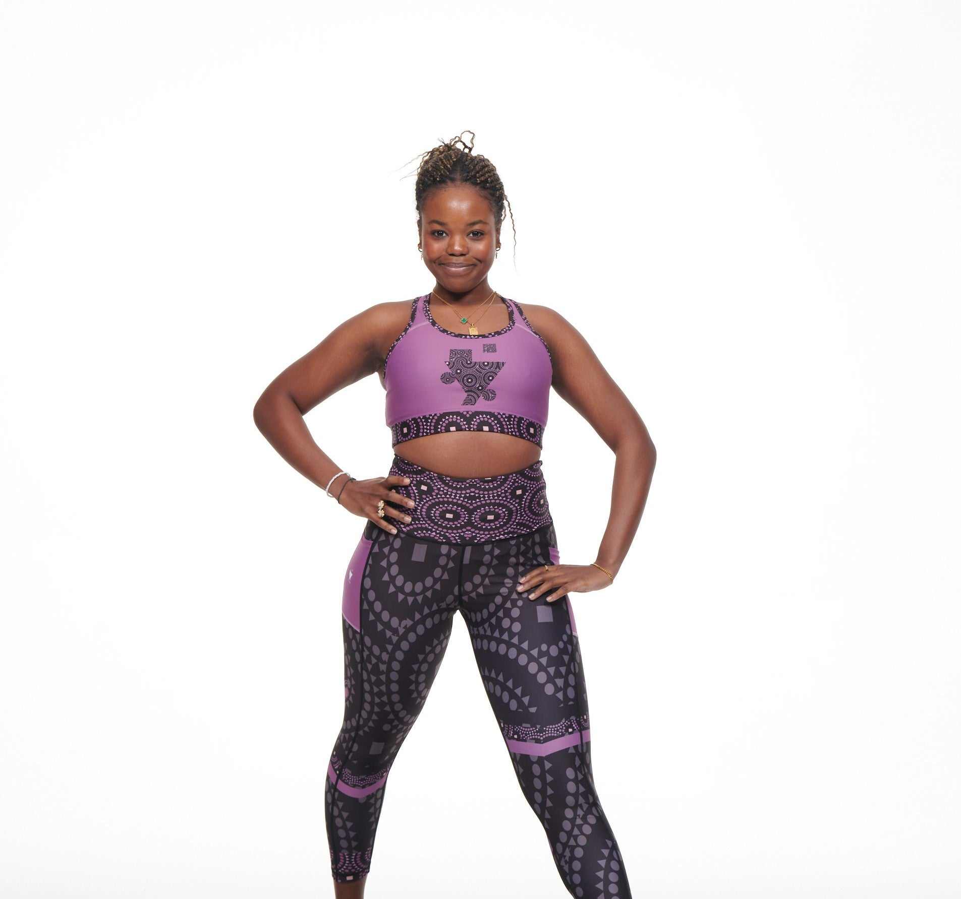 Purple racer-back sports bra with TYNA Signature Print featuring geometric shapes.
