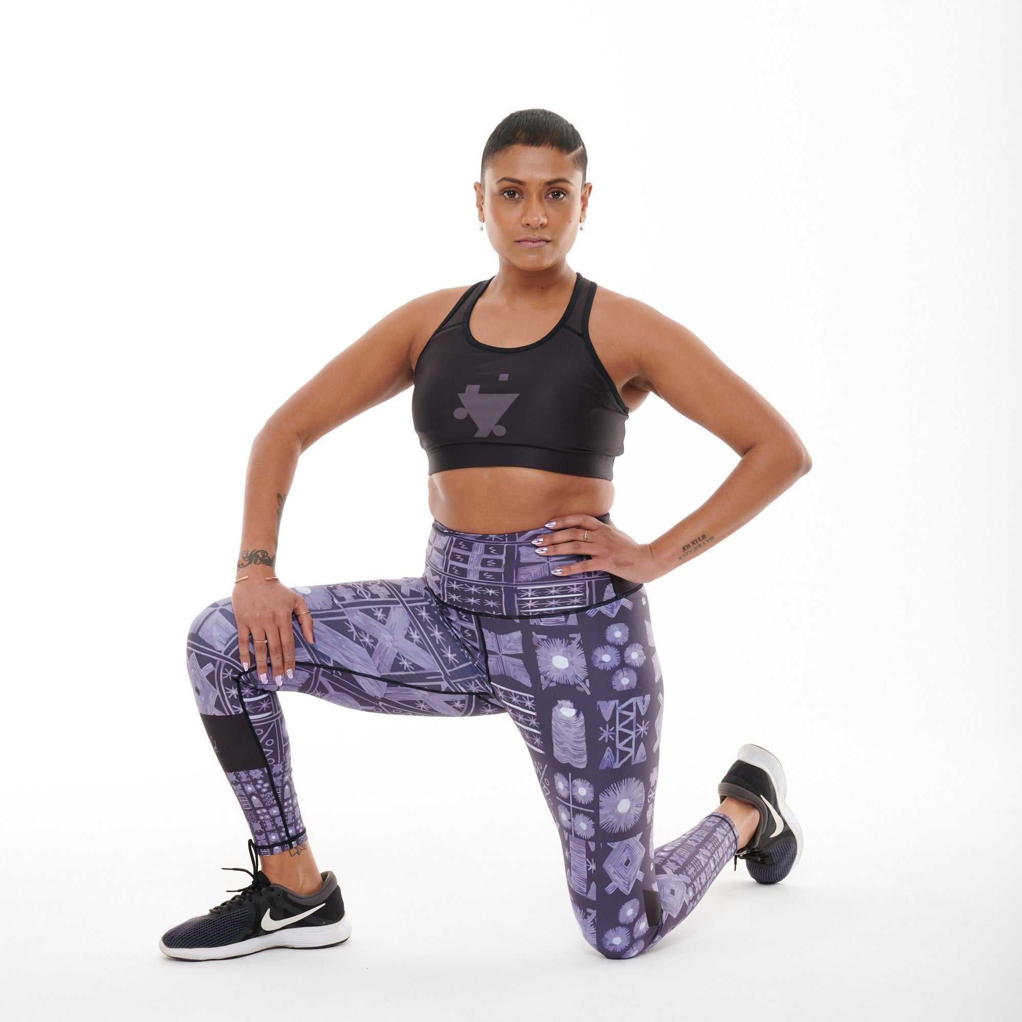 Adyre Vibrant Leggings with Adire-inspired print, modeled during a lunge exercise.