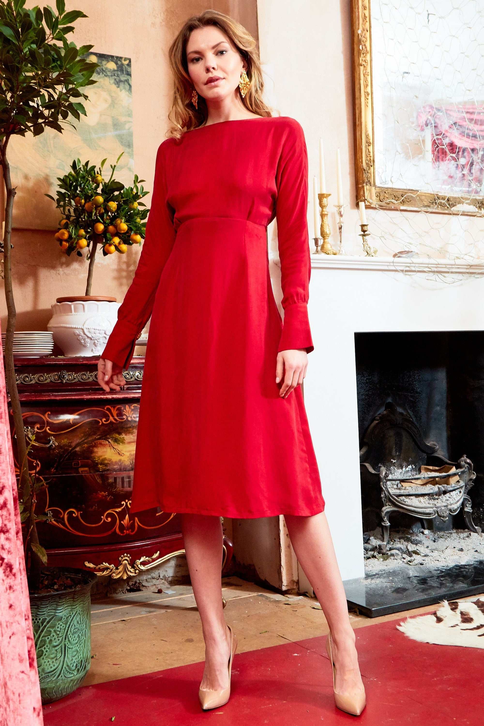 Red long sleeve midi dress with cinched waist and versatile neckline, crafted from sustainable silk-like Cupro fabric.