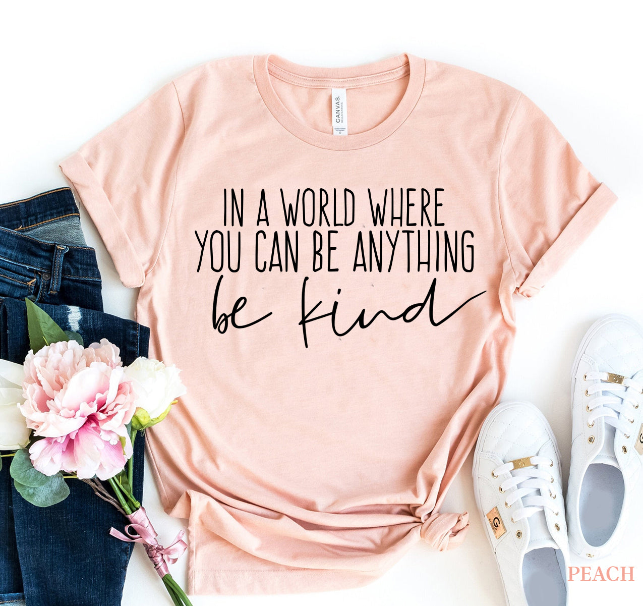 Peach "Be Kind" T-shirt with motivational text, made of premium cotton for soft feel and durable print.