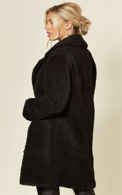 Stud Button Borg Teddy Coat (1905), oversized fit, black, hip length, popper button fastening.