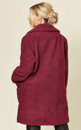 Oversized hip length borg teddy coat with stud button fastening and side pockets.