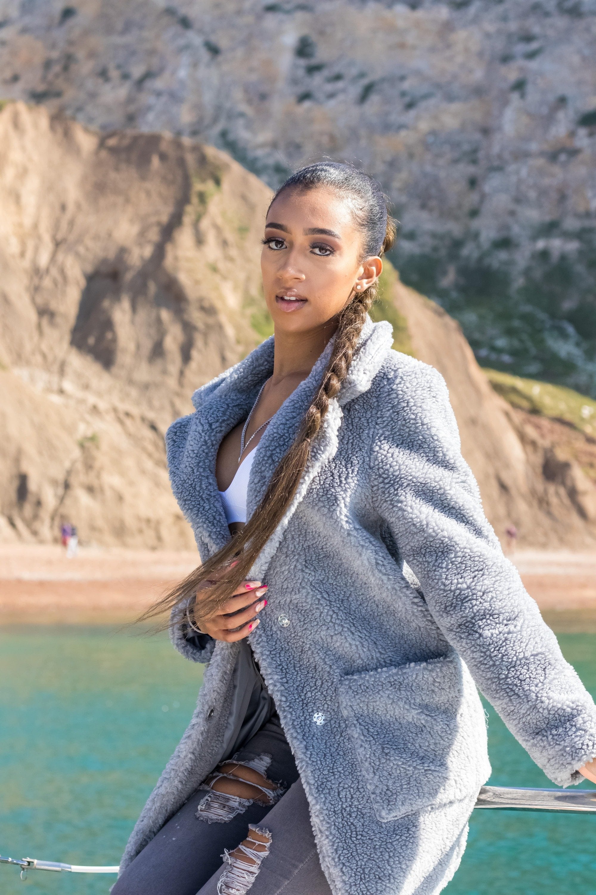 Woman wearing oversized gray Stud Button Borg Teddy Coat (1905) outdoors.