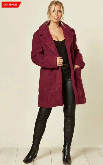 Oversized burgundy borg teddy coat with stud buttons and side pockets.